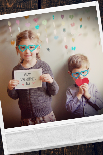 Polaroid photo of two kids wearing heart glasses