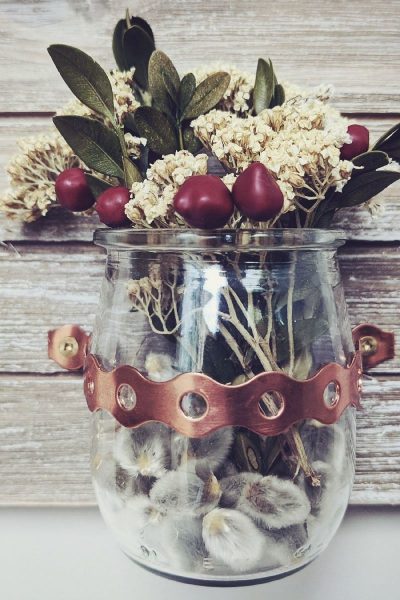 Mini vase with flowers on rustic background