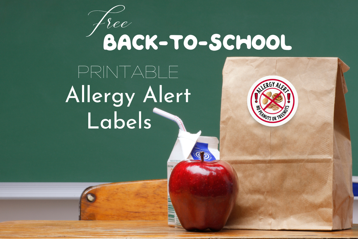Allergy alert label on brown paper bag beside and apple and carton of milk in front of a green chalkboard on a wooden desk