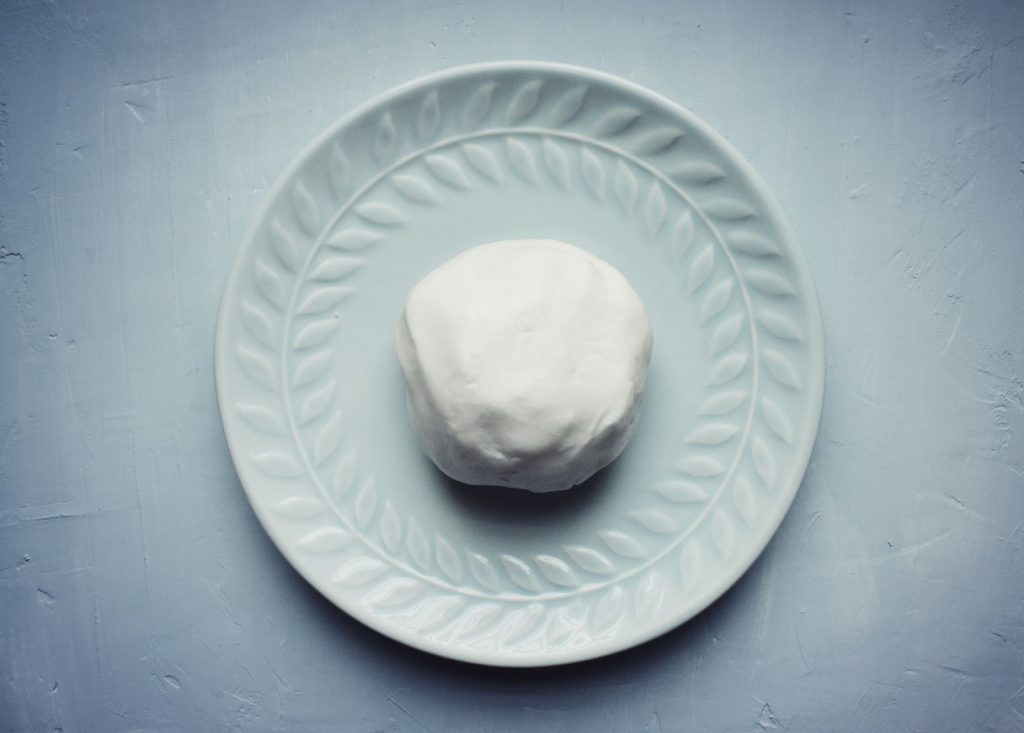 White dough on seafoam plate
