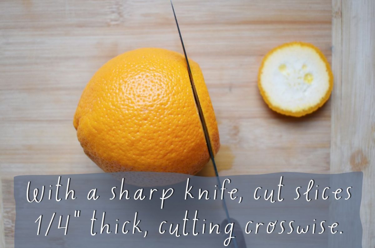 Knife cutting into a fresh orange
